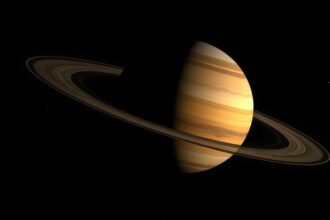 A high-contrast image of a large, Saturn-like exoplanet drifting alone in the vastness of space, with a few distant stars and galaxies visible in the background.