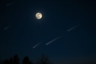 A high-resolution image of a night sky with a full moon and meteors streaking across the horizon, with a few trees or a landscape in the foreground to provide context.